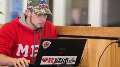 A young person working on a laptop