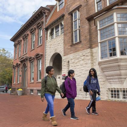 three students walking on campus