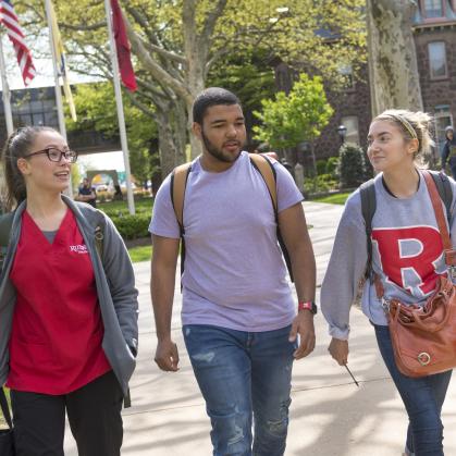 Three students walking on campus