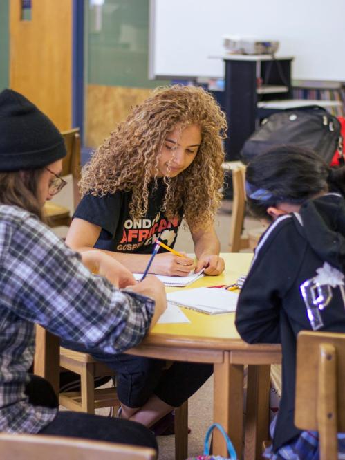 students sitting at library table