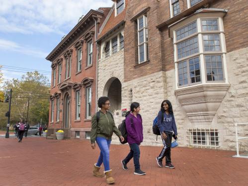 three students walking on campus